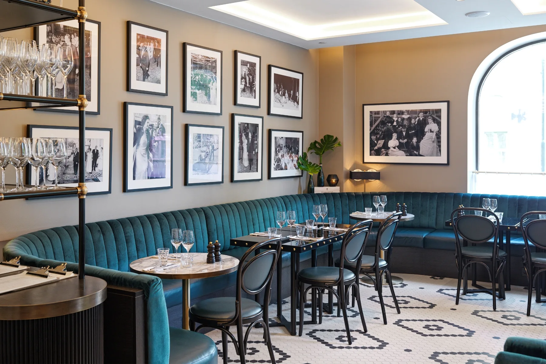 the restaurant interior features contract furniture with blue couches and framed pictures